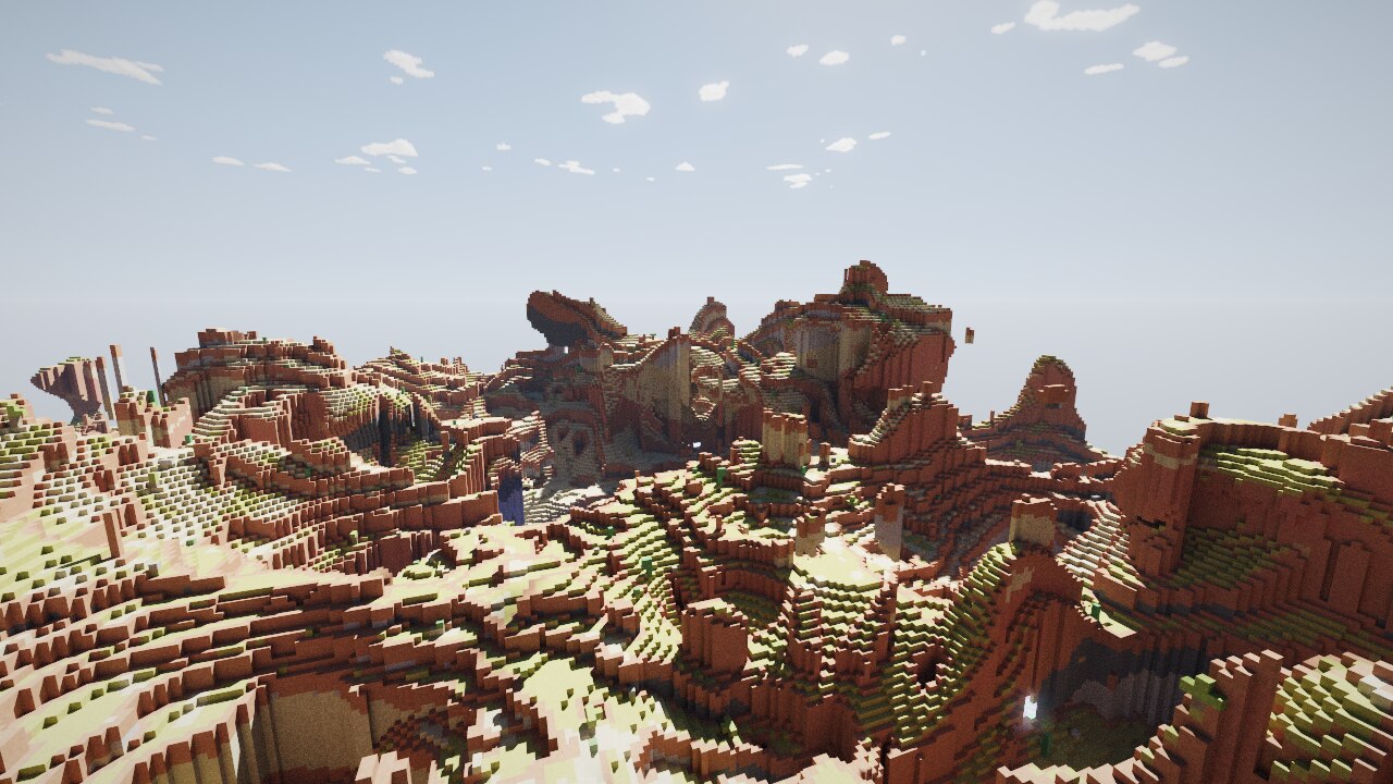 Terraced canyon walls in banded red rock, with a natural arch