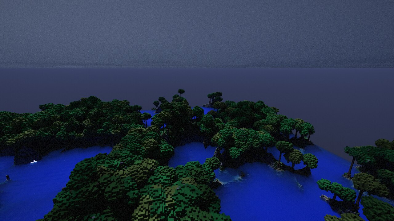 Moonlit rainforest over still blue water